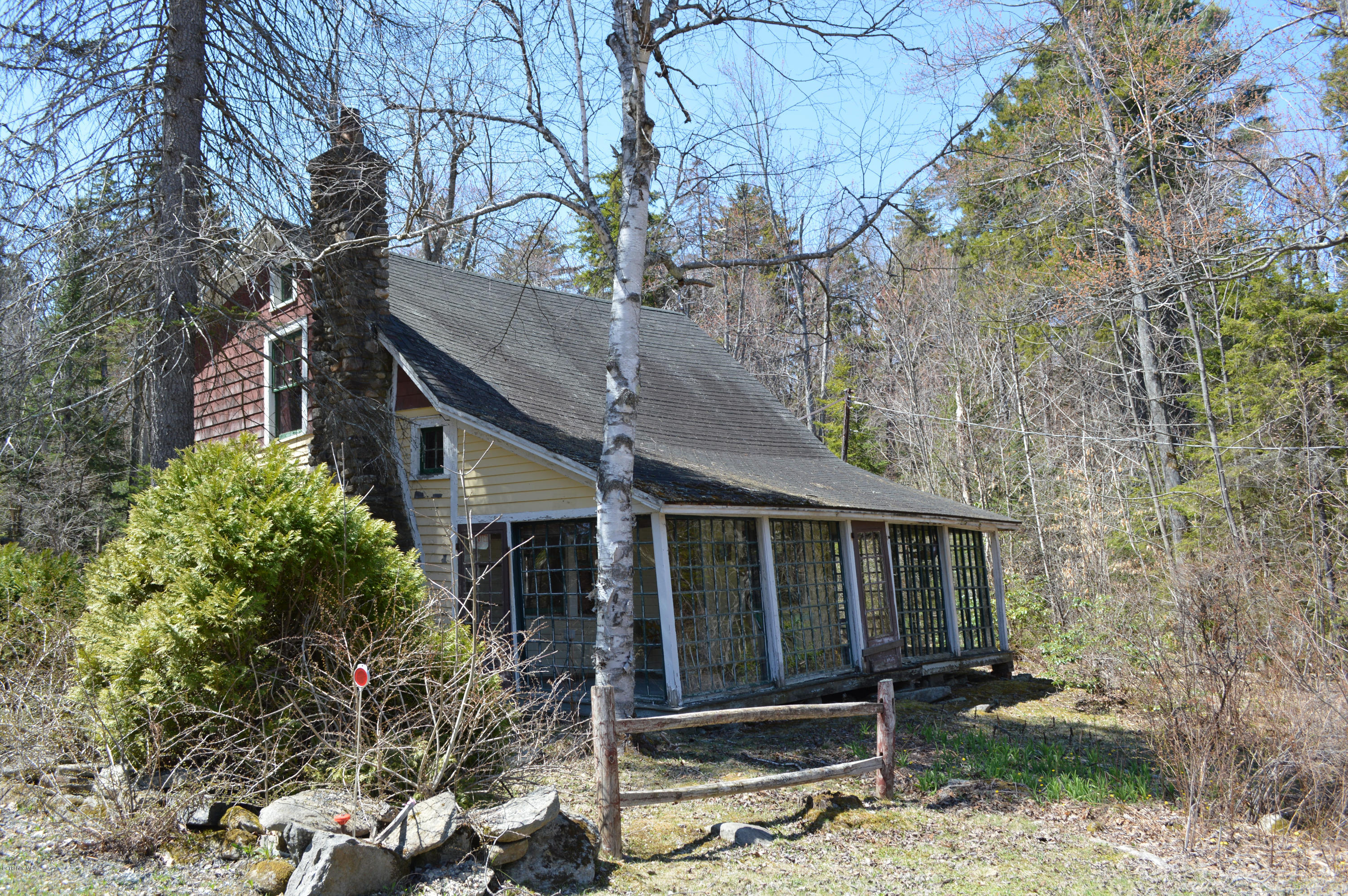 995 Plumb Road Becket, MA 01223 - Photo 6 of 12 a house with trees in front of it