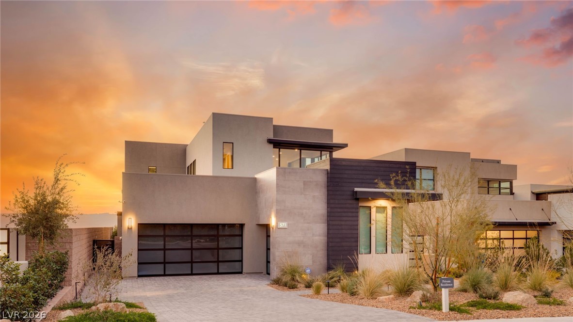 571 Overlook Rim Drive Henderson, NV 89012 - Photo 5 of 85 Contemporary house featuring decorative driveway, stucco siding, and a garage