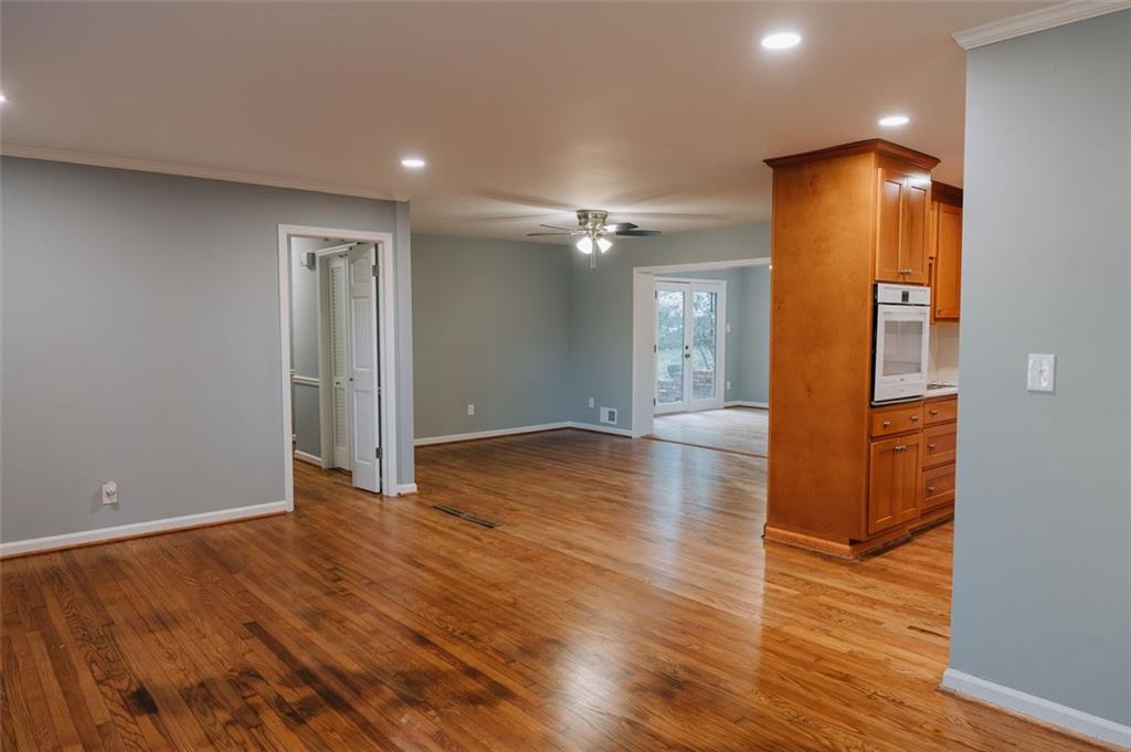 2744 Hunting Hill Lane Decatur, GA 30033 - Photo 4 of 16 a view of an empty room with wooden floor and a bathroom