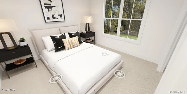 a bed sitting in a bedroom next to a window