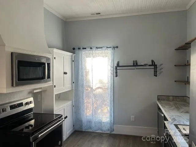 a kitchen with a refrigerator stove and microwave