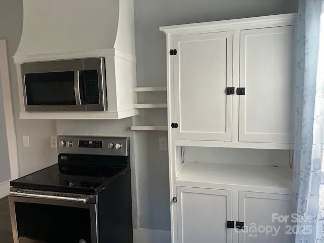 a kitchen with a stove and a microwave