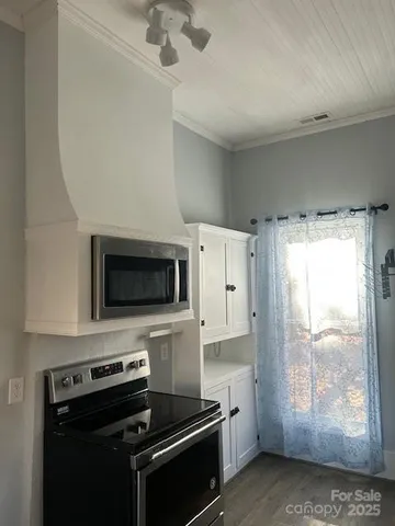 a kitchen with a stove a sink and a microwave