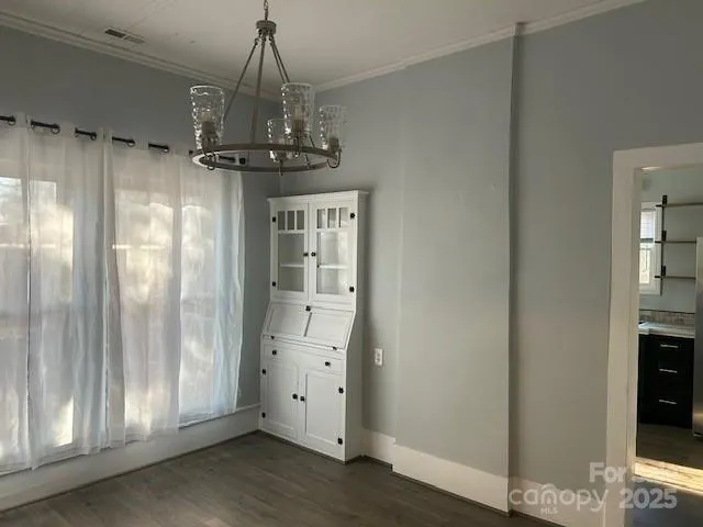 a view of a hallway with chandelier and entryway