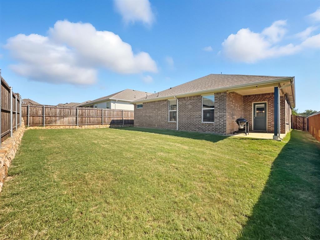 2216 Redwing Drive Denton, TX 76205 - Photo 35 of 38 a front view of a house with a garden