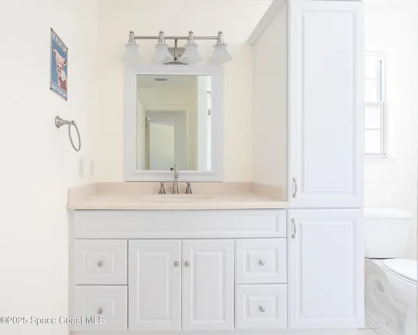 a living room with furniture a flat screen tv and a window