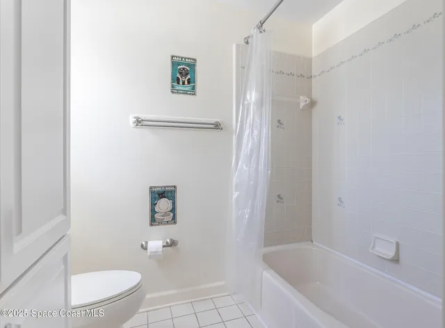 a bathroom with a granite countertop toilet sink and mirror
