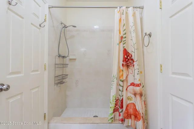 a view of storage and utility room with washer and dryer