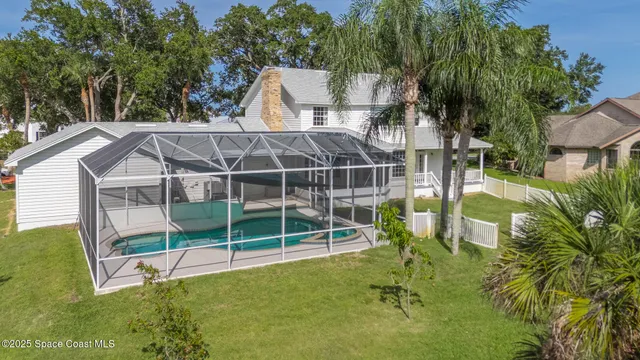 a view of a house with a yard and sitting area