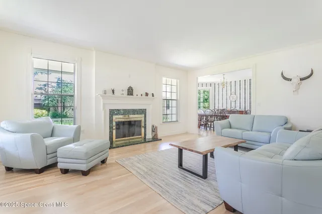 a living room with furniture and wooden floor
