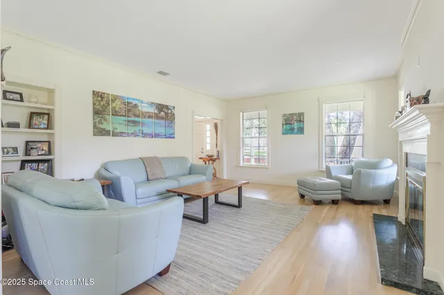 a living room with furniture and large windows