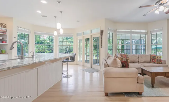 a large kitchen with granite countertop a large window and a sink