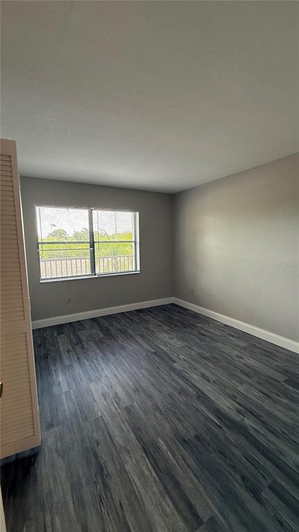 175 Kings Highway, Unit 1126 Punta Gorda, FL 33983 - Photo 13 of 17 an empty room with wooden floor and windows