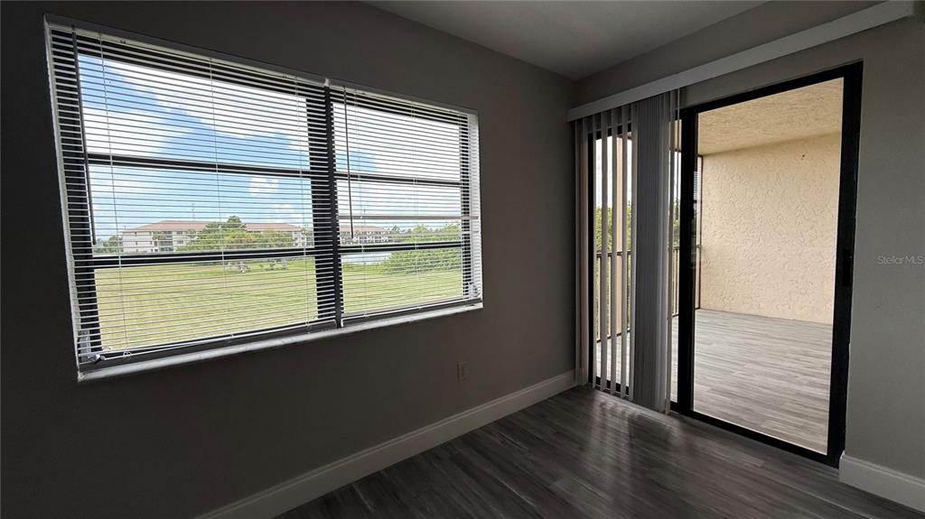 175 Kings Highway, Unit 1126 Punta Gorda, FL 33983 - Photo 9 of 17 a view of an empty room with wooden floor and a window