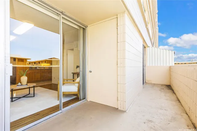 an empty room with sliding door and wooden floor