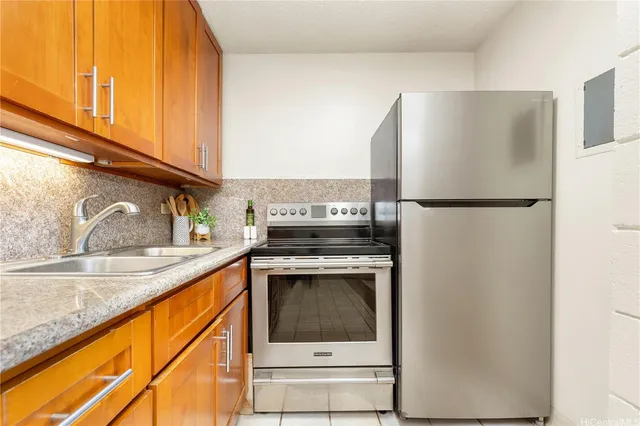 a kitchen with a refrigerator sink and stove