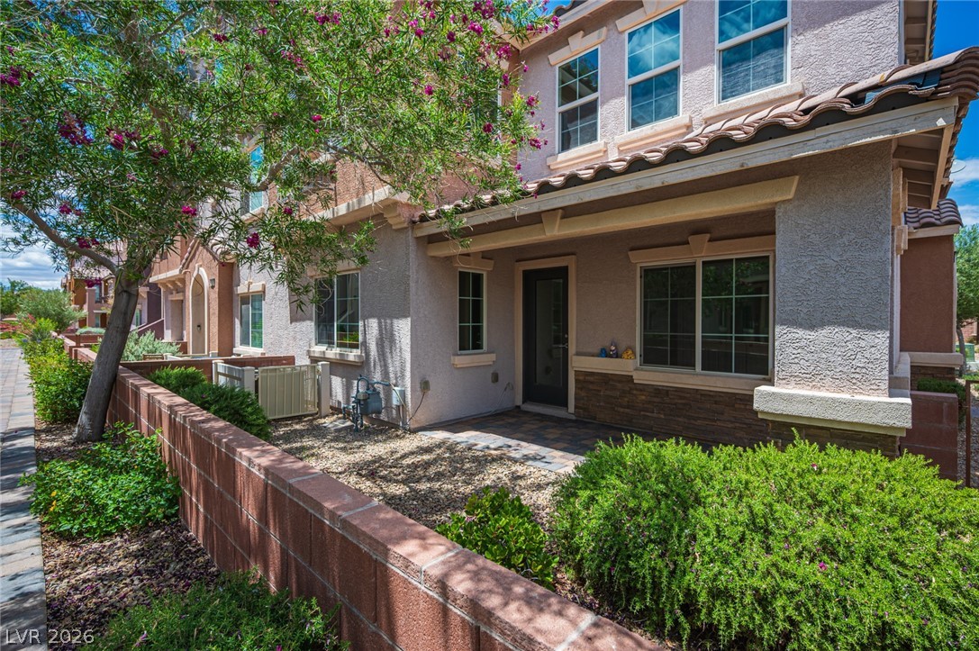 9916 Sable Point Street Las Vegas, NV 89178 - Photo 5 of 73 A well-maintained facade features mature landscaping and a welcoming front entrance.