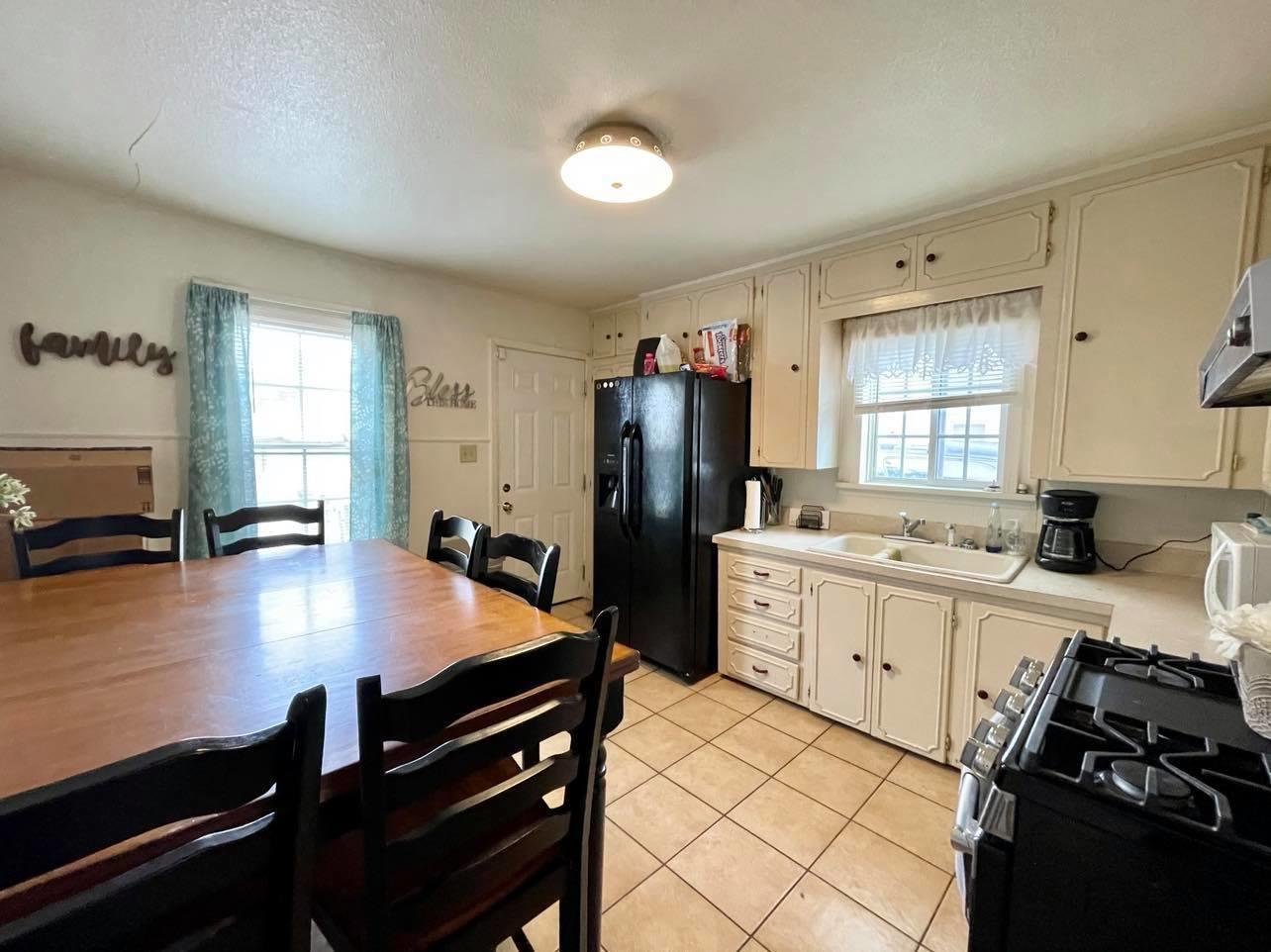 3812 South Hayden Street Amarillo, TX 79110 - Photo 4 of 9 a kitchen with a sink appliances and cabinets