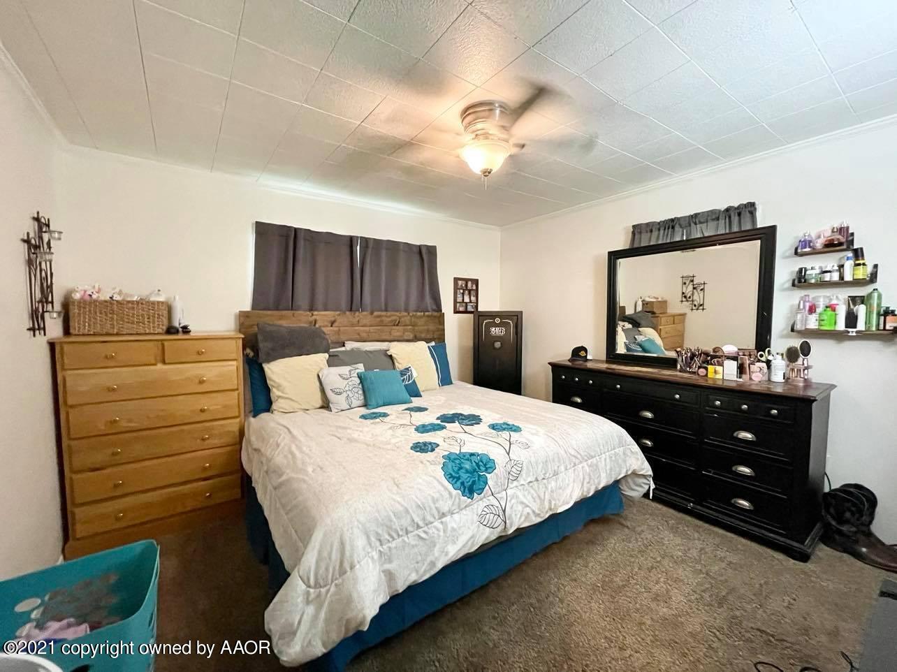 3812 South Hayden Street Amarillo, TX 79110 - Photo 6 of 9 a bedroom with a bed and a dresser
