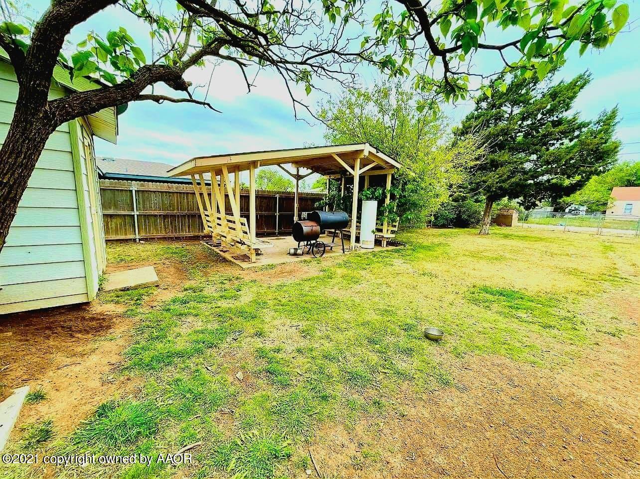 3812 South Hayden Street Amarillo, TX 79110 - Photo 8 of 9 a view of swimming pool with lawn chairs under an umbrella