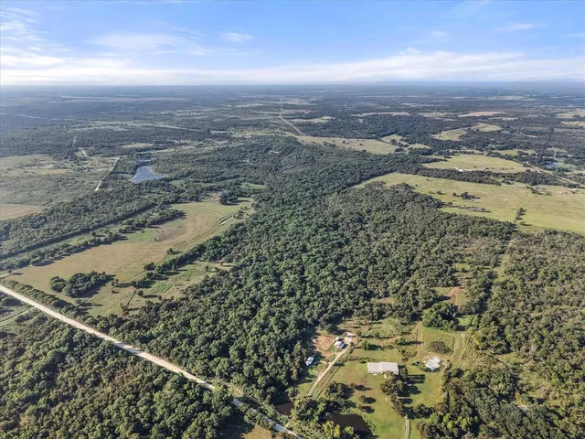 a view of a yard with wooden fence