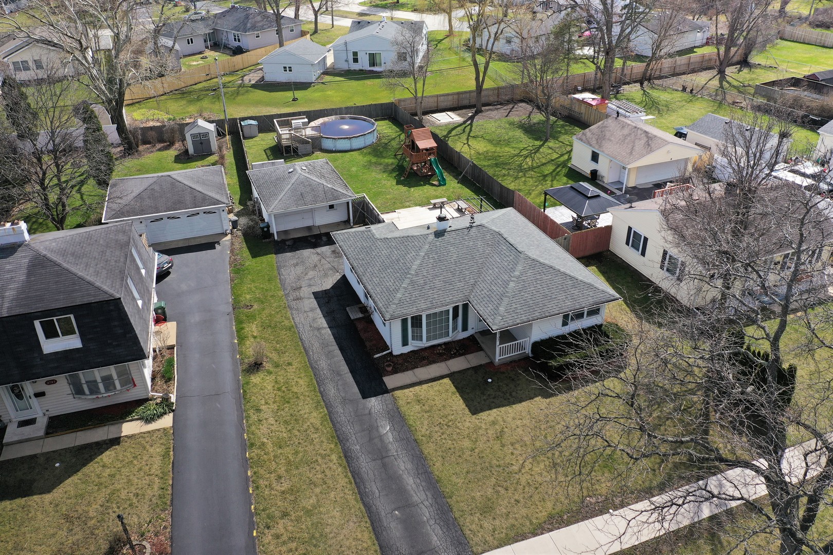 an aerial view of a house with garden space and street view