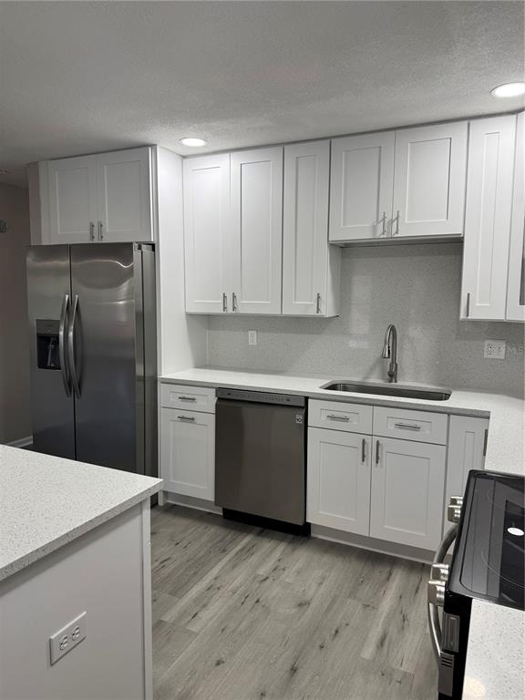 4550 Ewell Road Lakeland, FL 33811 - Photo 12 of 49 a kitchen with a sink stainless steel appliances and cabinets