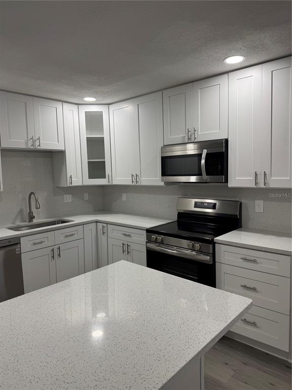 4550 Ewell Road Lakeland, FL 33811 - Photo 13 of 49 a kitchen with a sink a stove and cabinets