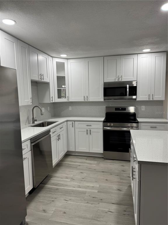 4550 Ewell Road Lakeland, FL 33811 - Photo 15 of 49 a white kitchen with granite countertop stainless steel appliances and white cabinets