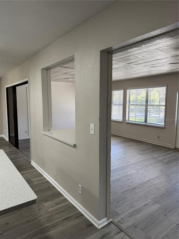 4550 Ewell Road Lakeland, FL 33811 - Photo 17 of 49 an empty room with wooden floor and a window