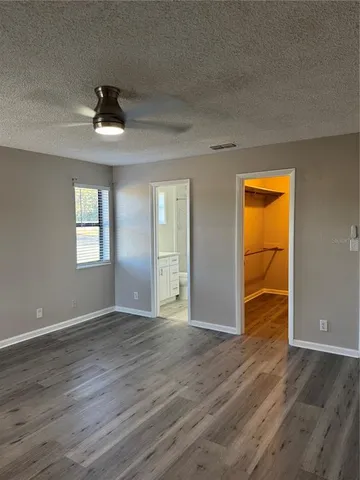 an empty room with wooden floor and closet