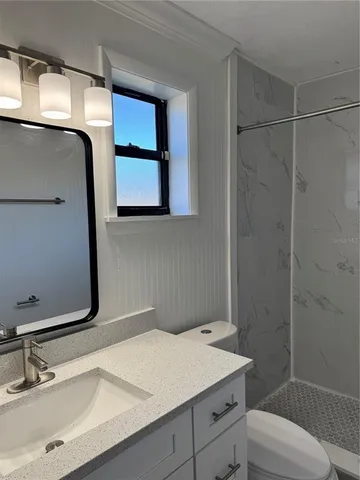 a bathroom with a shower and a toilet