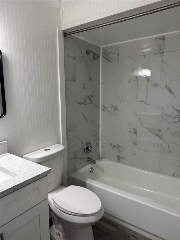 4550 Ewell Road Lakeland, FL 33811 - Photo 33 of 49 a bathroom with a granite countertop toilet a sink and a shower