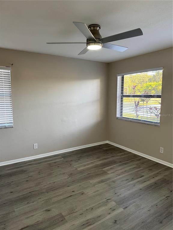 4550 Ewell Road Lakeland, FL 33811 - Photo 34 of 49 a view of an empty room with wooden floor and a window