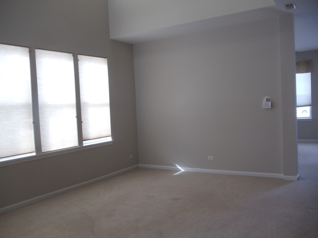 2977 Falling Waters Lane, Unit 2977 Lindenhurst, IL 60046 - Photo 2 of 25 an empty room with a window