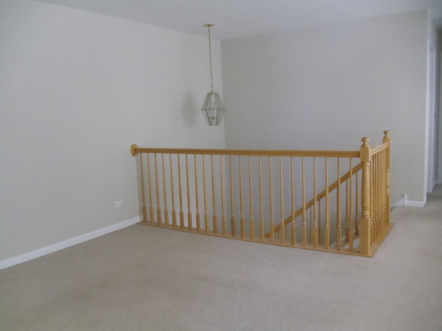 2977 Falling Waters Lane, Unit 2977 Lindenhurst, IL 60046 - Photo 12 of 25 a view of a hallway with staircase