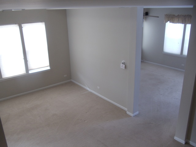 2977 Falling Waters Lane, Unit 2977 Lindenhurst, IL 60046 - Photo 13 of 25 an empty room that has a window