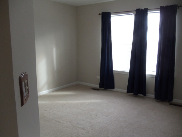 2977 Falling Waters Lane, Unit 2977 Lindenhurst, IL 60046 - Photo 19 of 25 an empty room with windows