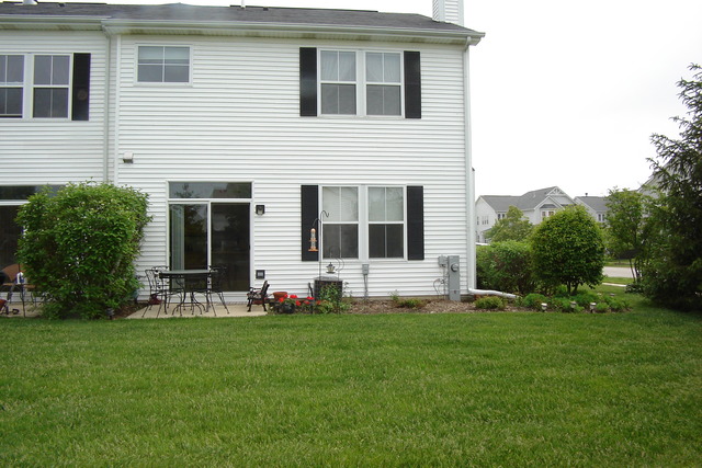 2977 Falling Waters Lane, Unit 2977 Lindenhurst, IL 60046 - Photo 20 of 25 a view of an house with backyard space and garden