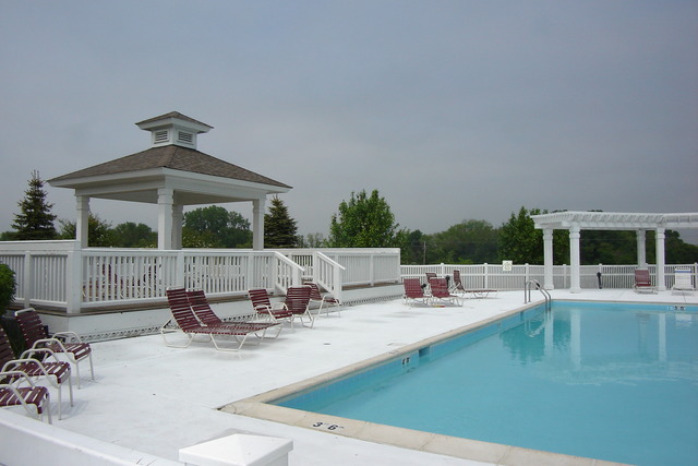 2977 Falling Waters Lane, Unit 2977 Lindenhurst, IL 60046 - Photo 24 of 25 a view of a swimming pool and lounge chairs