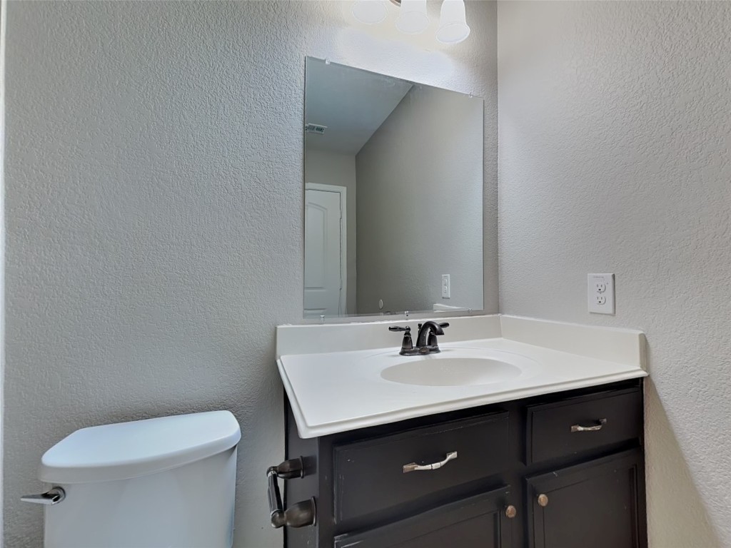 1525 Treeta Trail Kyle, TX 78640 - Photo 12 of 16 a bathroom with a sink and a toilet