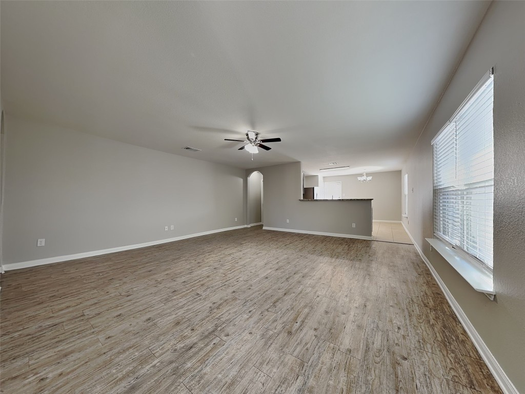 1525 Treeta Trail Kyle, TX 78640 - Photo 2 of 16 wooden floor in an empty room with a window