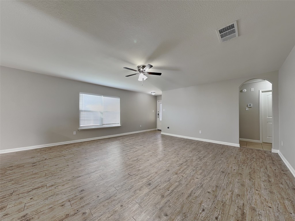 1525 Treeta Trail Kyle, TX 78640 - Photo 3 of 16 wooden floor in an empty room