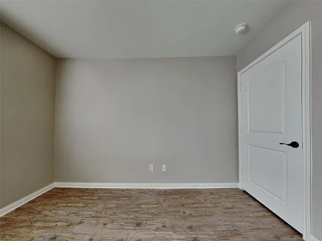 a view of an empty room and wooden floor