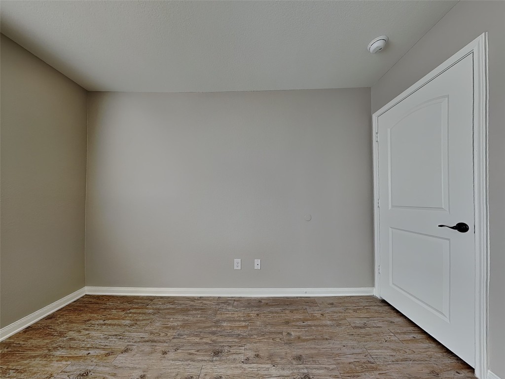 1525 Treeta Trail Kyle, TX 78640 - Photo 6 of 16 a view of an empty room and wooden floor