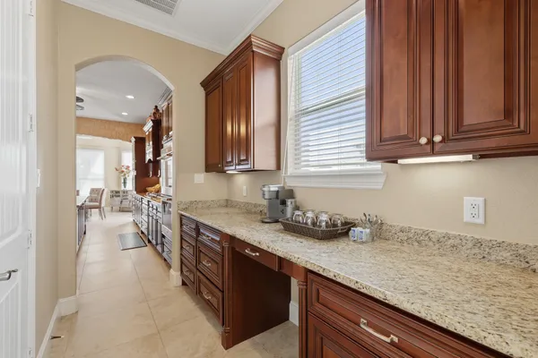 a large white kitchen with a large counter space