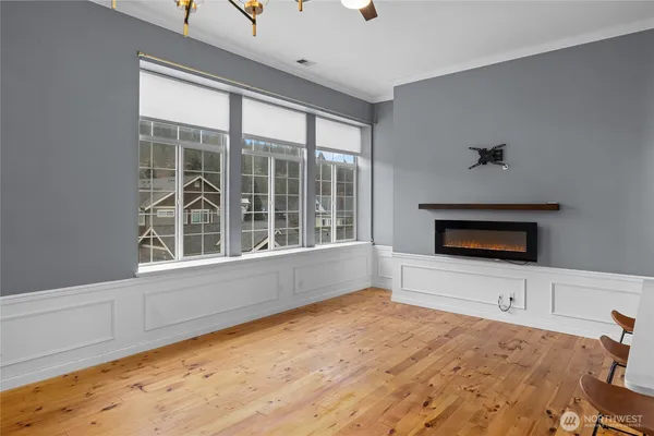 a view of an empty room with a window and fireplace