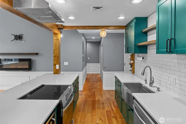 a kitchen with a sink a counter top space and appliances