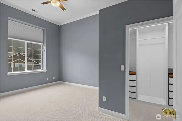 an empty room with windows and closet