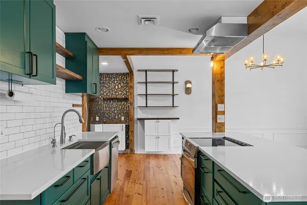 a kitchen with a sink stove and cabinets